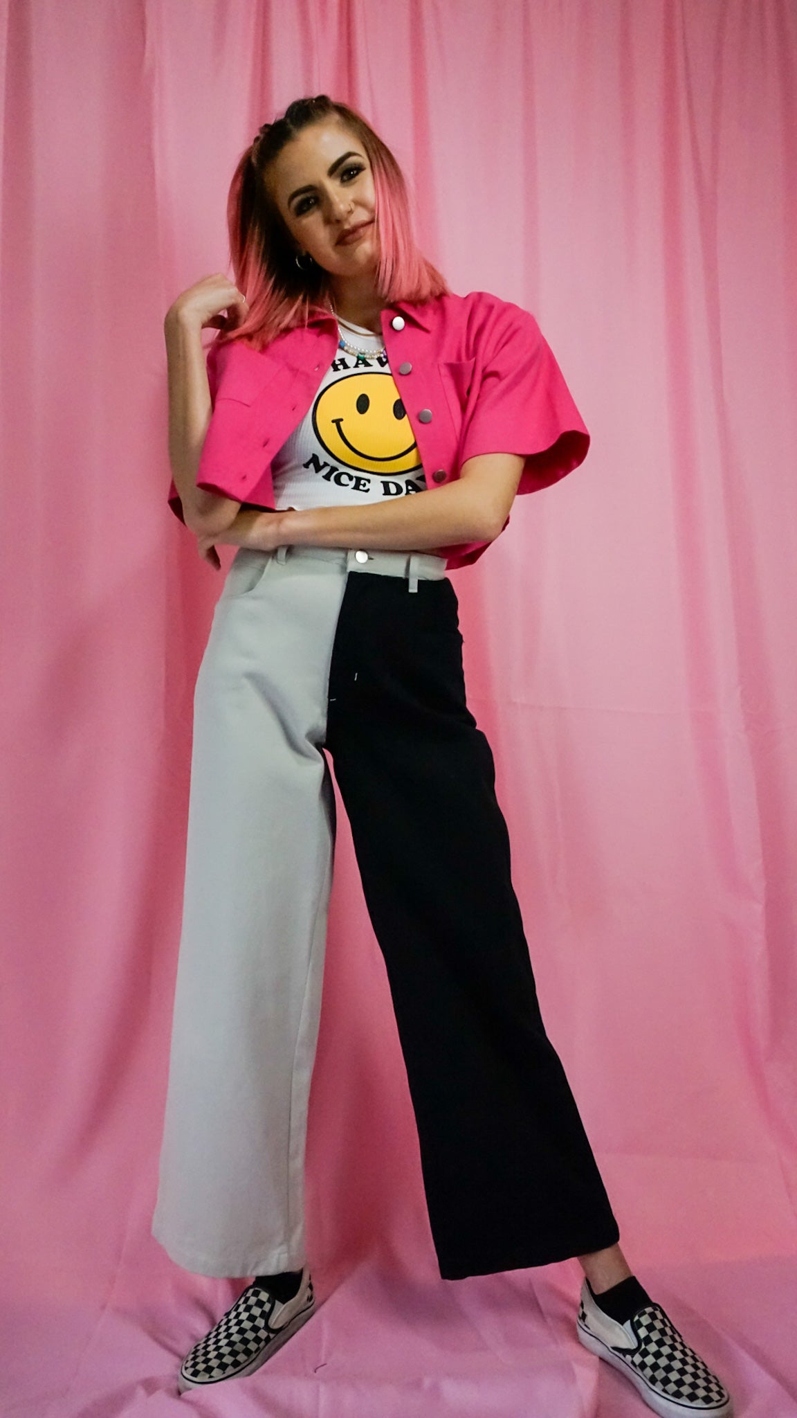 smiley face tank top with pink structured crop top and color block wide denim